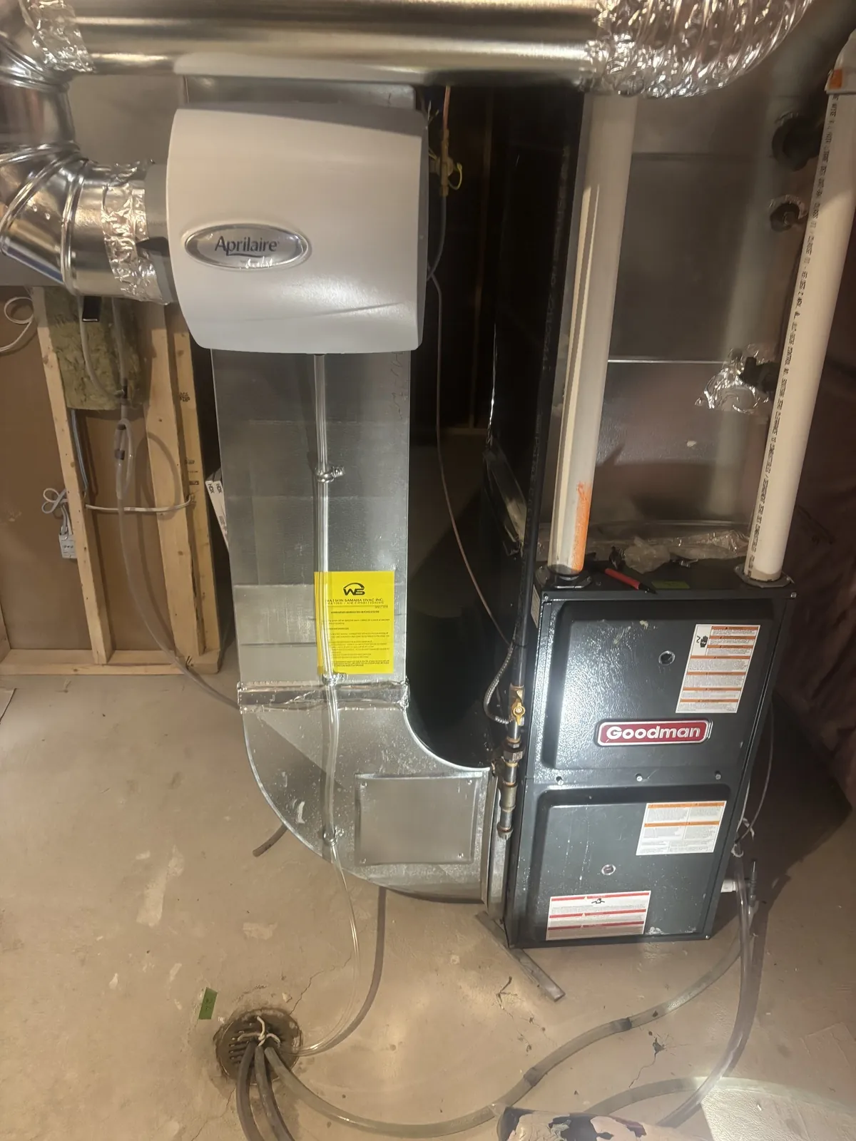 Gas furnace installed in a basement with the humidifier and return duct beside it