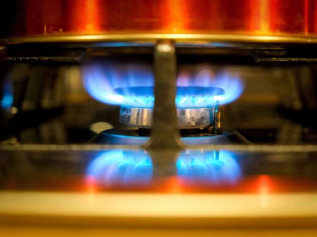 Blue flame burning across a gas burner
