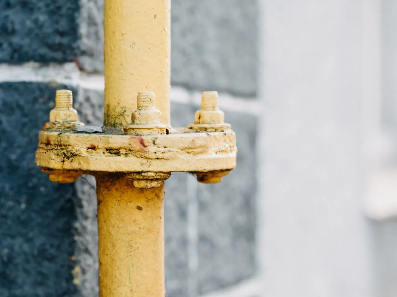 Yellow-coded natural gas pipe with a bolted flange fitting