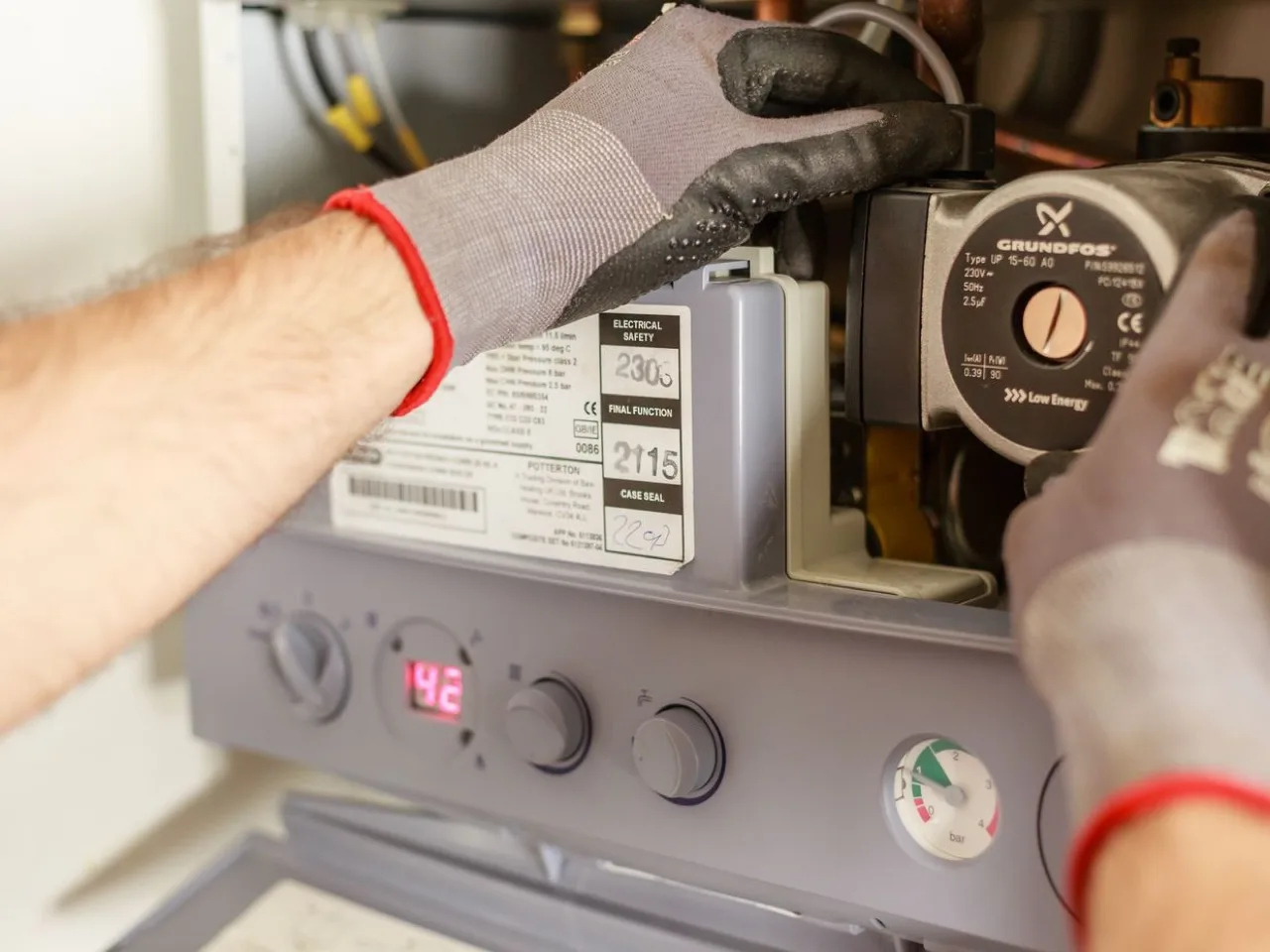 Gas technician working on a gas-fired boiler