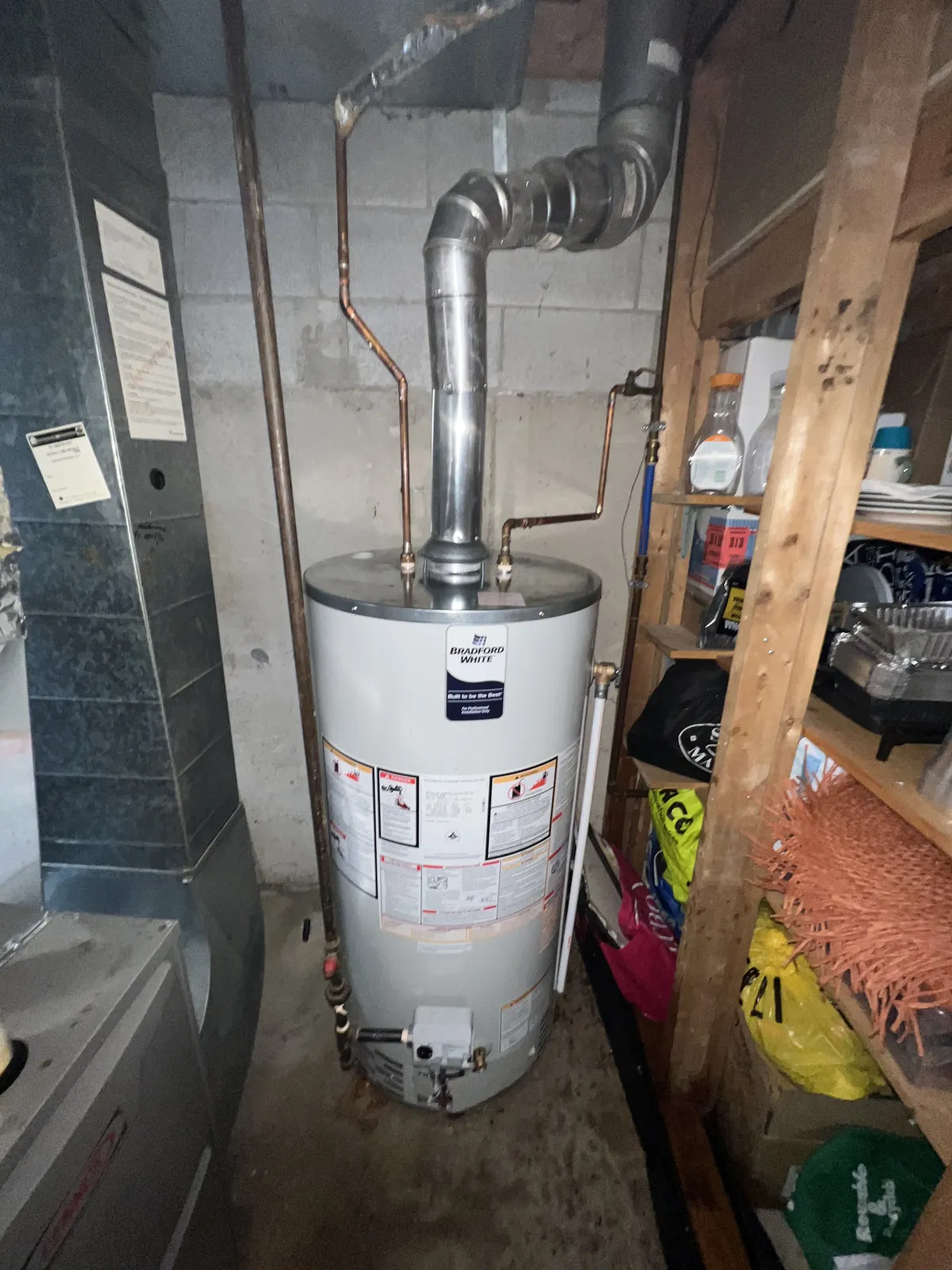 Hot water tank in a utility room with the vent connector running overhead