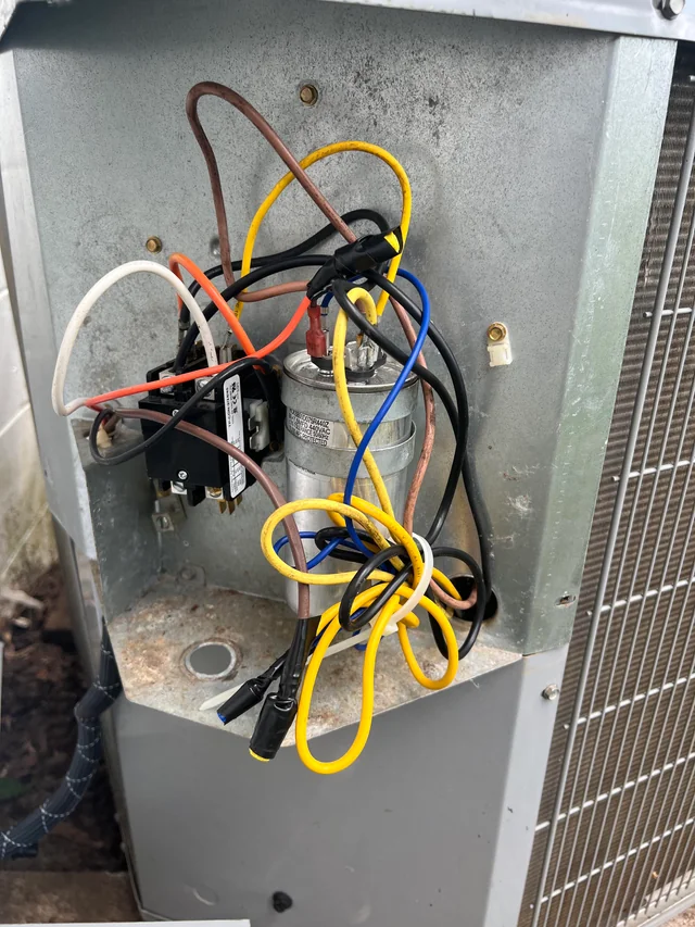 Air conditioner capacitor and wiring exposed for repair service