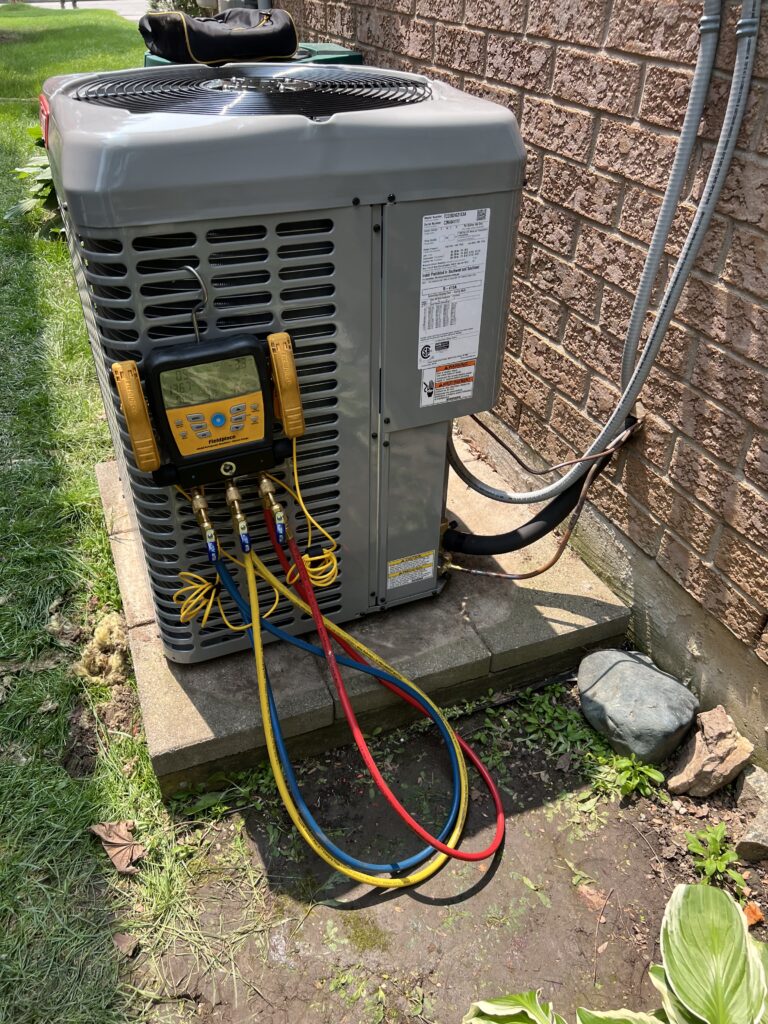 Air conditioner repair in Mississauga – Real Deal HVAC technician servicing outdoor AC unit