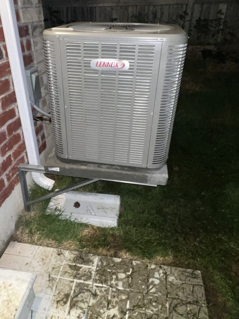 Lennox central air conditioner on raised wall bracket and concrete shelf — Mississauga home