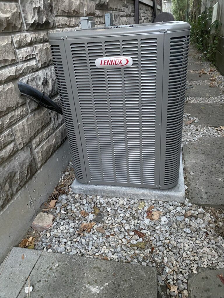 Central AC outdoor condenser with gauges attached for diagnostic service