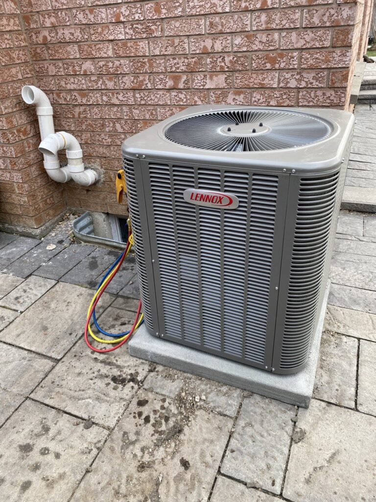 Lennox central air conditioner installation on concrete pad — Mississauga home