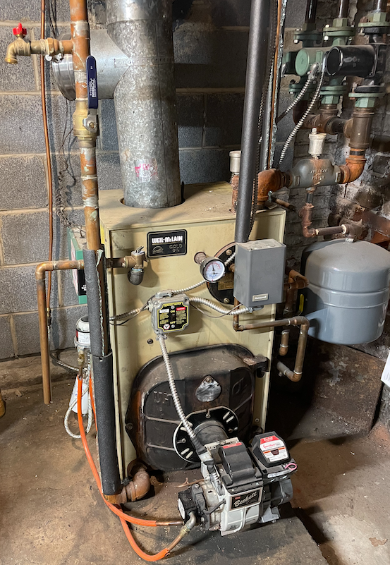 Old oil-fired boiler unit in need of repair or replacement