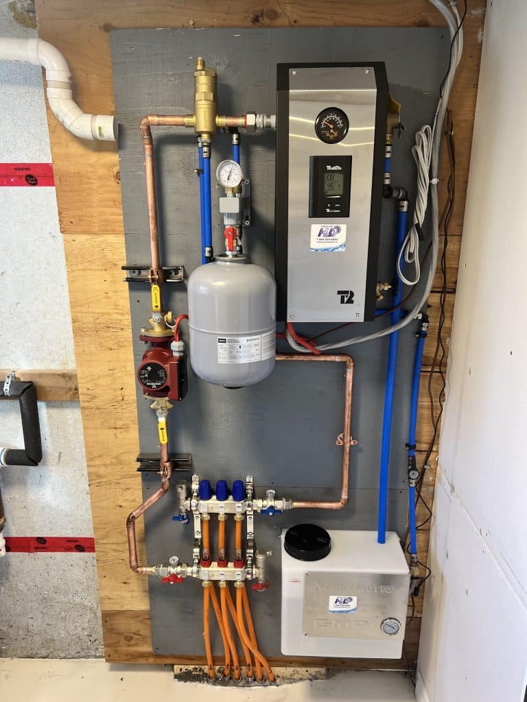 Radiant floor heating system with manifold and boiler setup