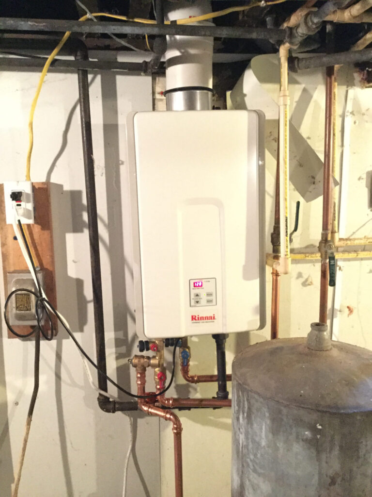 Tankless water heater mounted on a basement wall in a Mississauga home