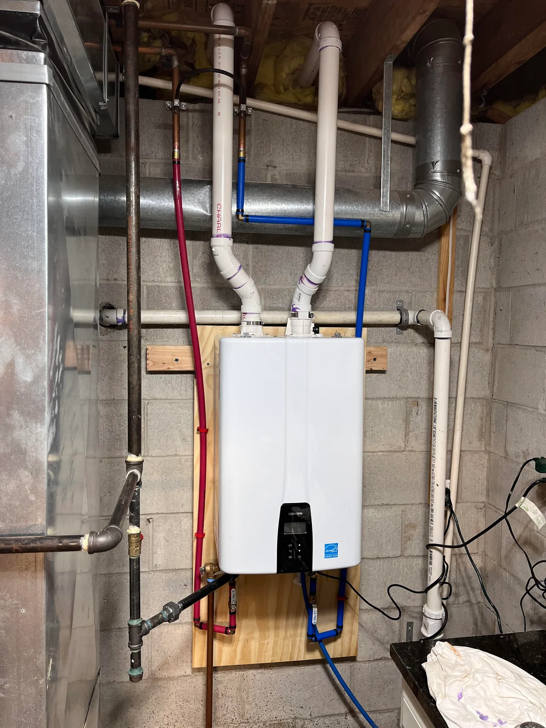 Tankless water heater installation in the GTA with wall-mounted unit and proper venting