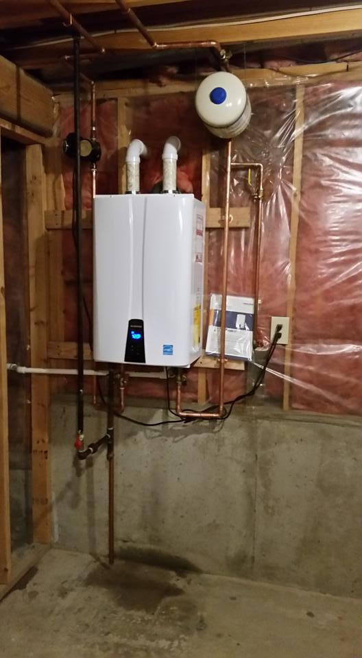 Tankless water heater installation in Mississauga, Ontario with wall-mounted unit and proper venting