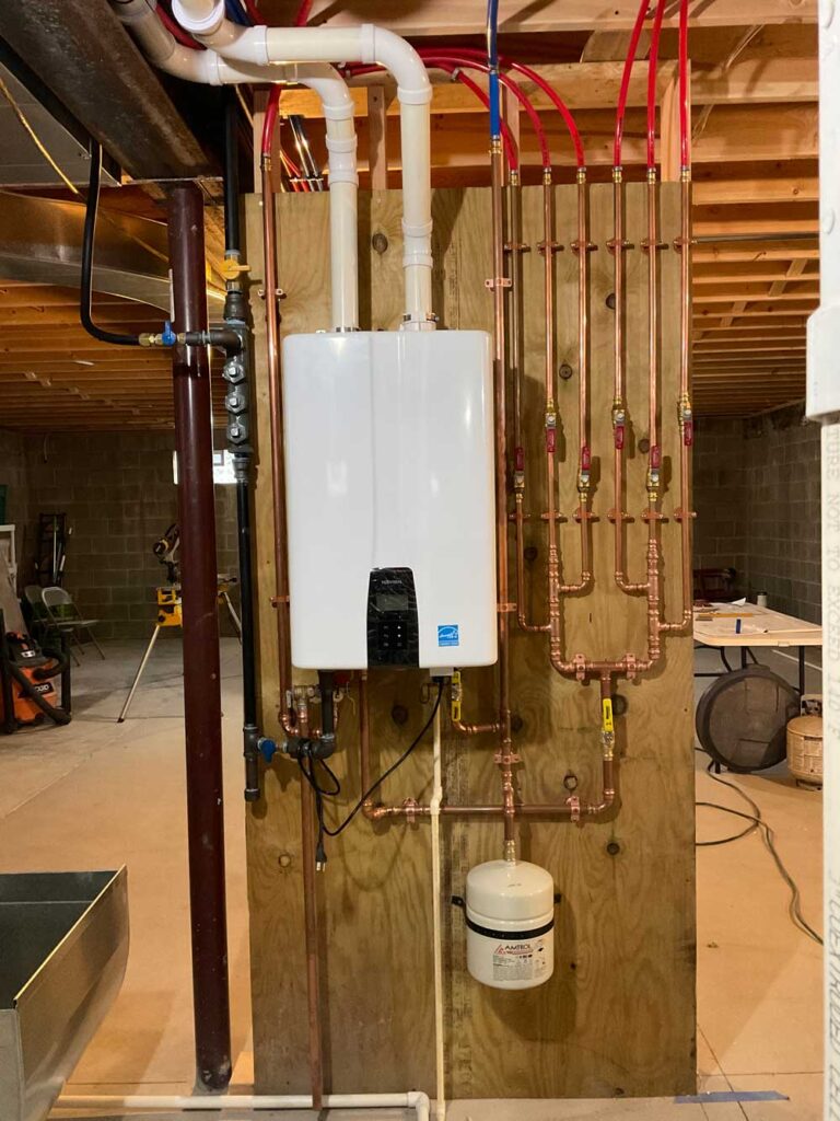 Tankless water heater installation in Mississauga, ON with wall-mounted unit and proper venting